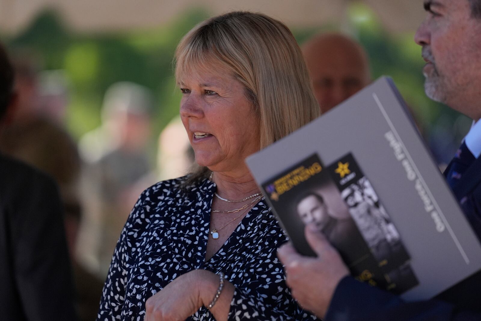 Ms. Sue Conger-Williams, Fred Benning's granddaughter, talks with friends during a ceremony honoring new namesake on Wednesday, April 16, 2025, in Fort Benning, Ga. (AP Photo/Brynn Anderson)