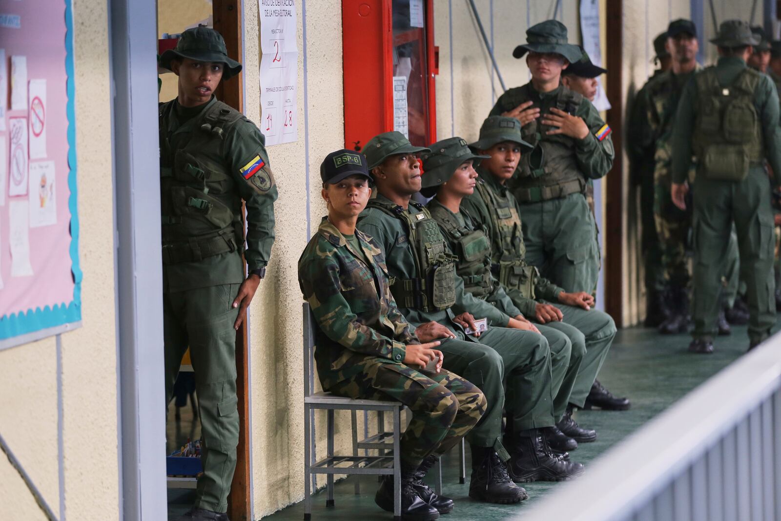 Military personnel line up to vote in legislative and local elections in Caracas, Venezuela, Sunday, May 25, 2025. (AP Photo/Cristian Hernandez)