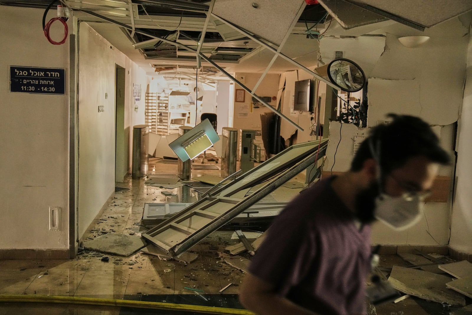 A medical staff walks along a damaged area at the Soroka hospital complex after it was hit by a missile fired from Iran in Be'er Sheva, Israel, Thursday, June 19, 2025. (AP Photo/Leo Correa)