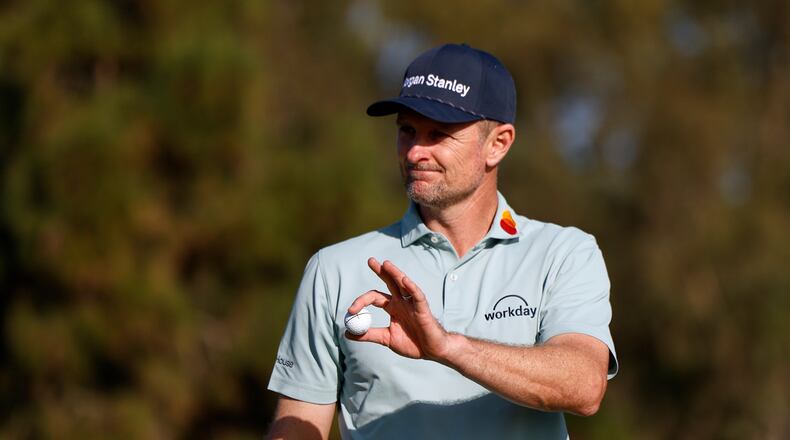 Justin Rose, of England, waves after finishing on the eighth hole on the North Course at Torrey Pines during the first round of the Farmers Insurance Open golf tournament Thursday, Jan. 29, 2026, in San Diego. (AP Photo/Caroline Brehman)