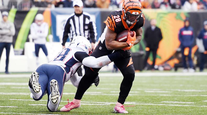 CINCINNATI, OHIO - DECEMBER 15: Joe Mixon #28 of the Cincinnati Bengals carries the ball during the first half against the New England Patriots in the game at Paul Brown Stadium on December 15, 2019 in Cincinnati, Ohio. (Photo by Bobby Ellis/Getty Images)