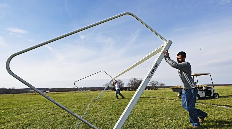 Dave Kemper, left, and Jeremy Whaley with S.L.A.M. Services set up goals at Smith Park for the Middletown Spring Blast soccer tournament. This is the 20th year of the tournament that takes place March 18-19 at soccer fields in Middletown and Franklin. NICK GRAHAM/STAFF