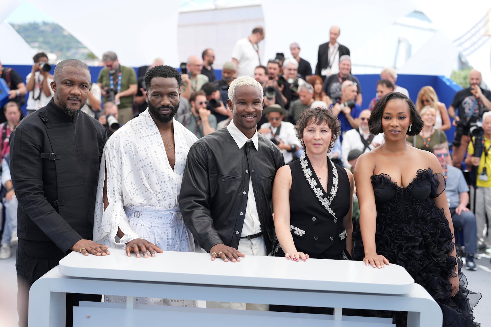 Wale Davies, from left, Sope Dirisu, director Akinola Davies, producer Rachel Dargavel and producer Funmbi Ogunbanwo pose for photographers at the photo call for the film 'My Father's Shadow' at the 78th international film festival, Cannes, southern France, Sunday, May 18, 2025. (AP Photo/Natacha Pisarenko)