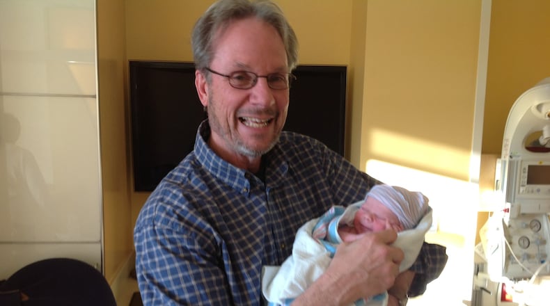 Miami University professor Dr. Richard Campbell holds his newborn grandson, Reese Anthony Campbell, who was born Jan. 29, 2014.
