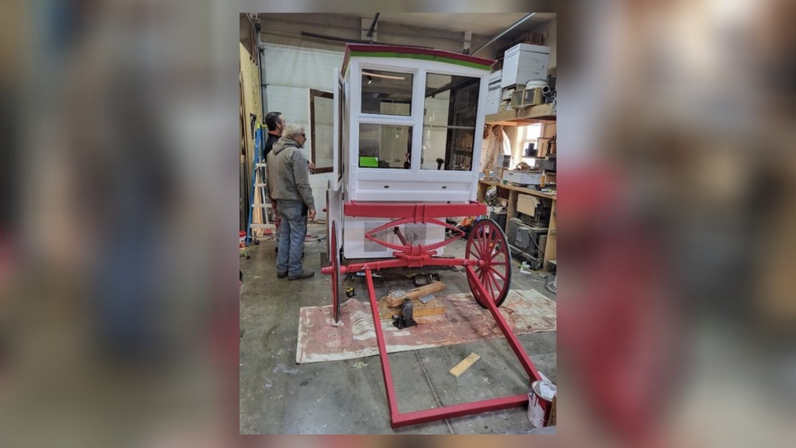 Hamburger Wagon owner Jack Sperry (left, background) reviews renovations made to the rolling business, which has sold its burger-pickle-onion combo at Market Square in Miamisburg since 1913. Sperry said the renovations are meant to extend the wagon's longevity and make it easier to clean. CONTRIBUTED