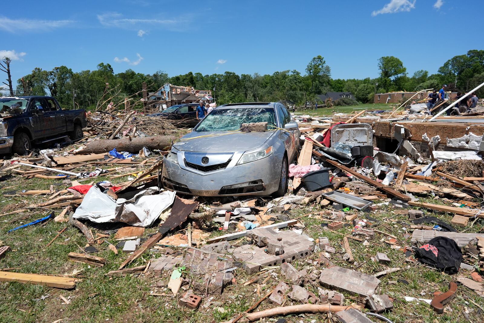 Debris covers the ground and damaged vehicles after a severe storm passed the area on Saturday, May 17, 2025 in London, Ky. (AP Photo/Carolyn Kaster)