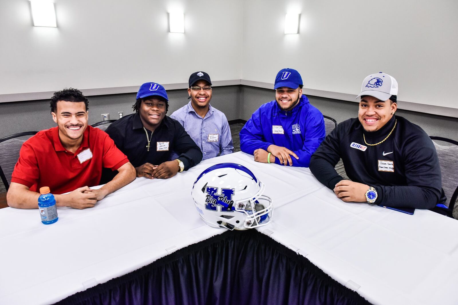 Hamilton was represented during the Greater Miami Conference Signing Day event Wednesday at the Sharonville Convention Center. Pictured left to right are Gabe Mathews (Malone), Maleek Jarrett (Urbana), Quinton Henderson (Urbana), Dillon Stone (Urbana) and Jason Smith (Notre Dame College). NICK GRAHAM/STAFF
