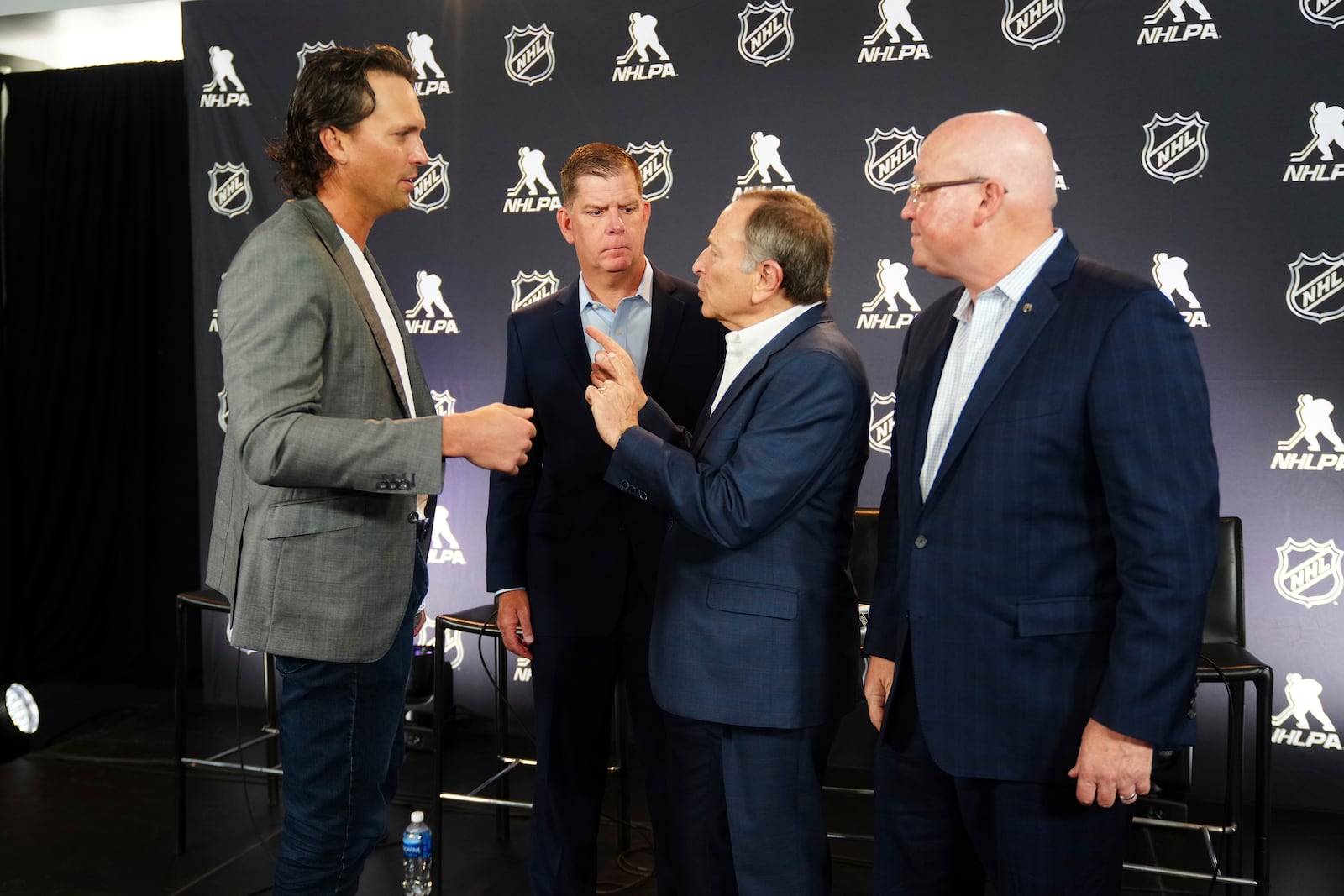 From left to right, Ron Hainsey, NHLPA Assistant Executive Director, Marty Walsh, NHLPA Executive Director, Gary Bettman, NHL Commissioner, and Bill Daly, NHL Deputy Commissioner, interact after a joint press conference before the NHL hockey draft Friday, June 27, 2025, in Los Angeles. (AP Photo/Damian Dovarganes)