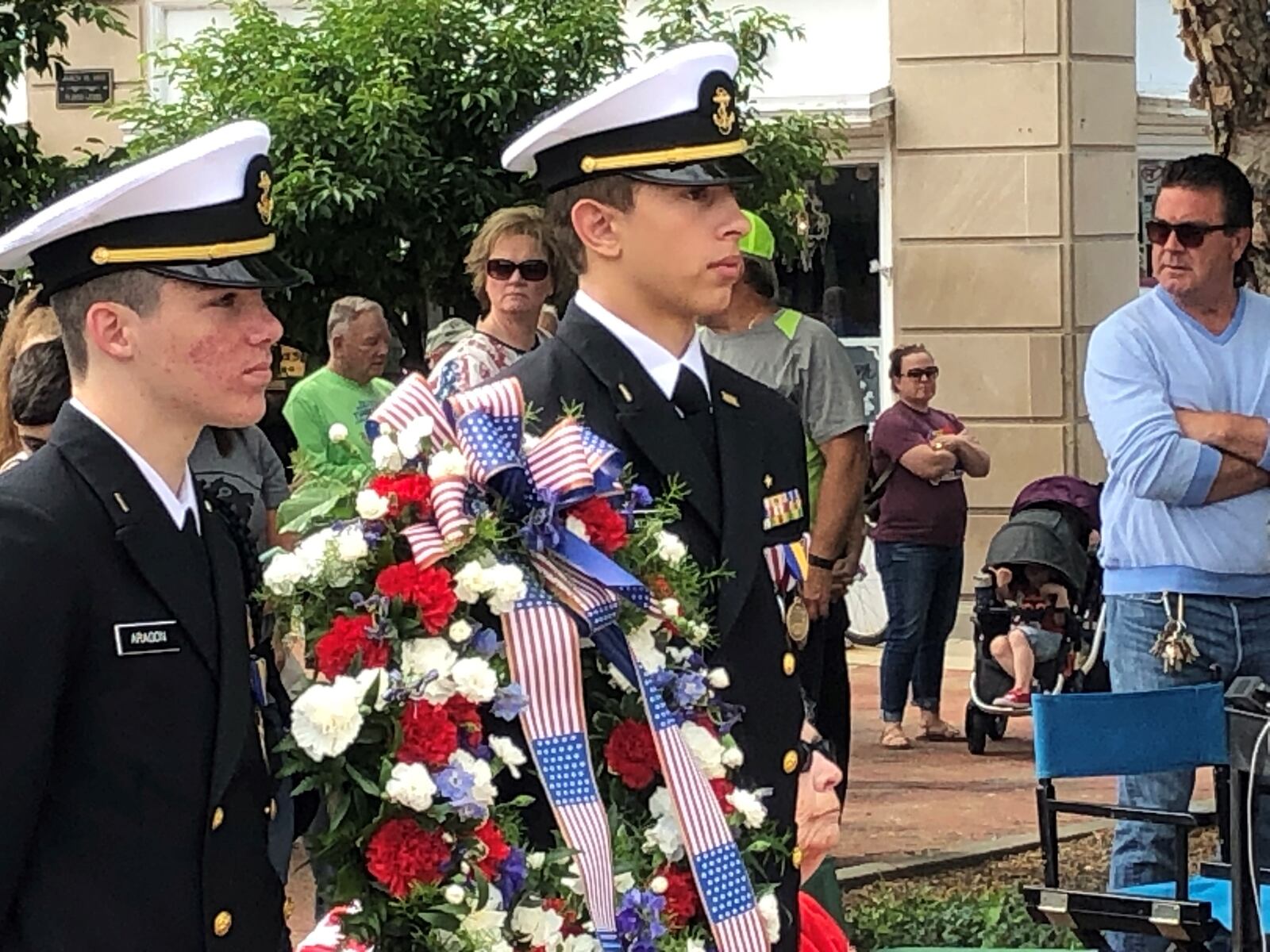Two members of the Hamilton High School Junior Naval ROTC prepare to carry the wreath to the steps of Soldiers, Sailors and Pioneers Monument in Hamilton Monday morning. RICK McCRABB/STAFF