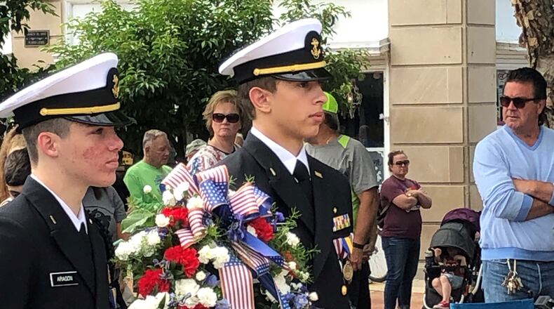 Two members of the Hamilton High School Junior Naval ROTC prepare to carry the wreath to the steps of Soldiers, Sailors and Pioneers Monument in Hamilton on Memorial Day 2021. RICK McCRABB/STAFF FILE PHOTO
