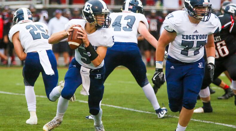 Edgewood quarterback Corbin Craft (5) looks for an open receiver while teammate Andy Weaver (77) blocks during a Sept. 1 game against host Franklin at Atrium Stadium. The visiting Cougars lost 49-21. GREG LYNCH/STAFF