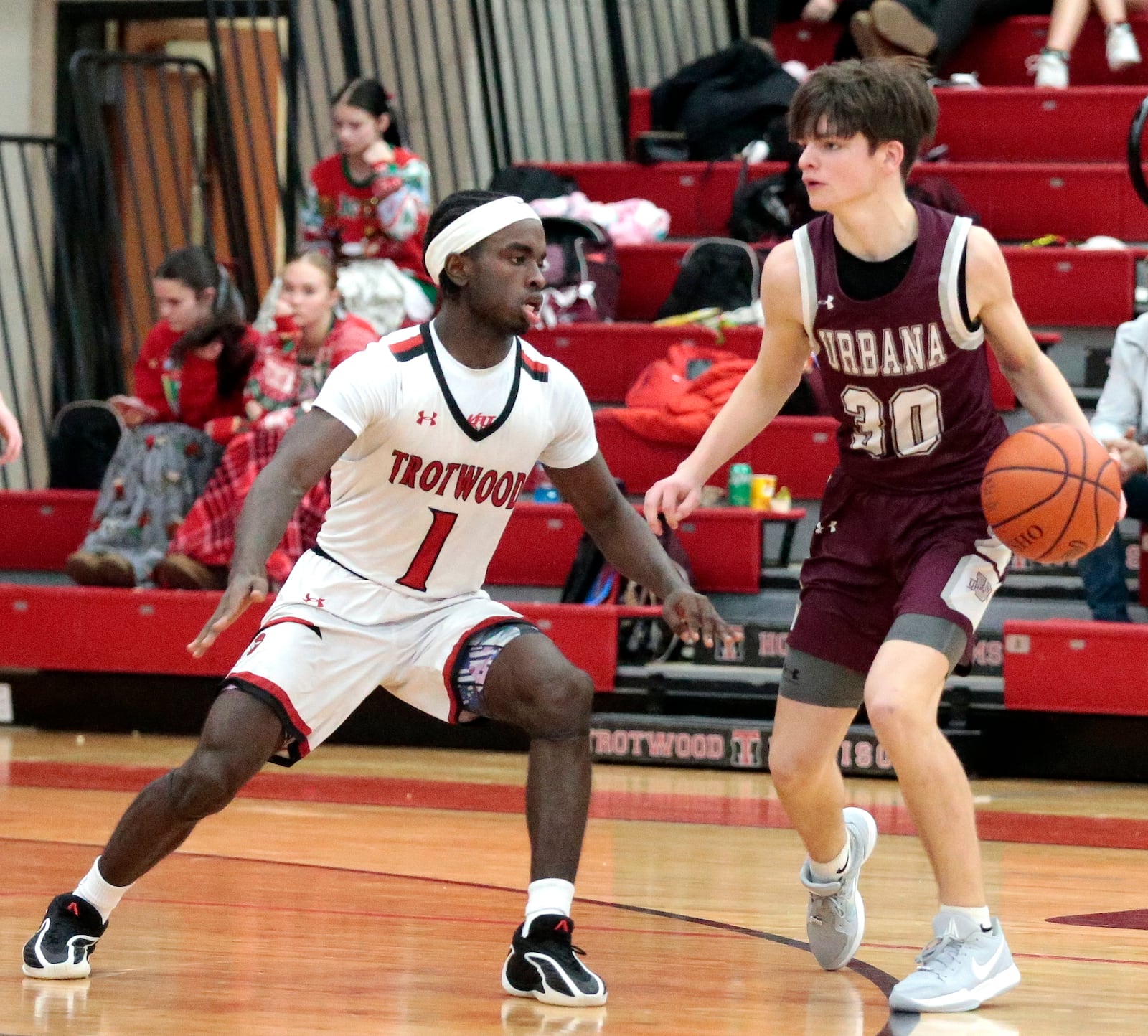 Urbana sophomore Drew Dixon controls the ball against Trotwood senior Je'Carious Reaves. Trotwood defeated Urbana 61-50 in a boys basketball game Tuesday, Dec. 23, 2025, in Trotwood. STEVEN WRIGHT / STAFF