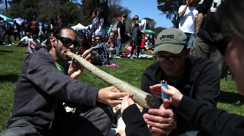A marijuana user attempts to light an oversized joint during a 420 Day celebration on “Hippie Hill” in Golden Gate Park on April 20, 2018 in San Francisco, California. In the first year that marijuana is legal for recreational use in California, thousands of marijuana enthusiasts gathered in Golden Gate Park to celebrate 420 day, the de facto holiday for marijuana advocates, with large gatherings and “smoke outs” in many parts of the United States. JUSTIN SULLIVAN / GETTY IMAGES
