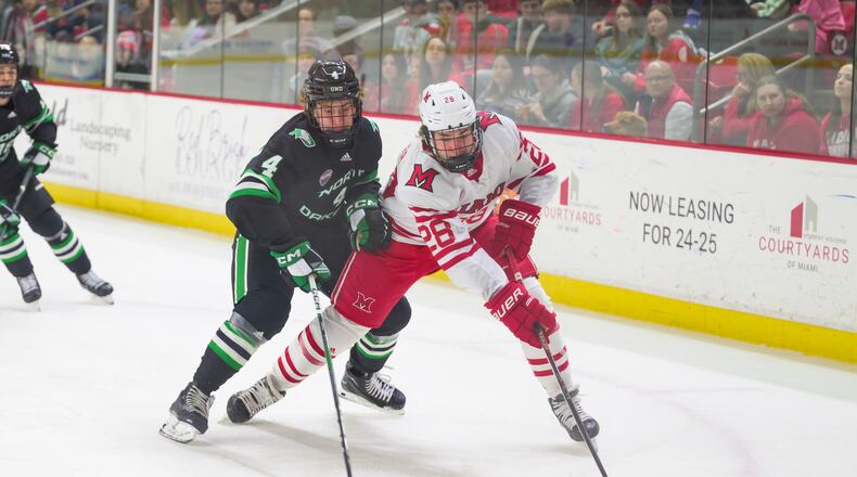 Miami's Tanyon Bajzer battles North Dakota's Jake Livanavage for the puck during Saturday night's game in Oxford. Bella Sagarese/Miami Athletics