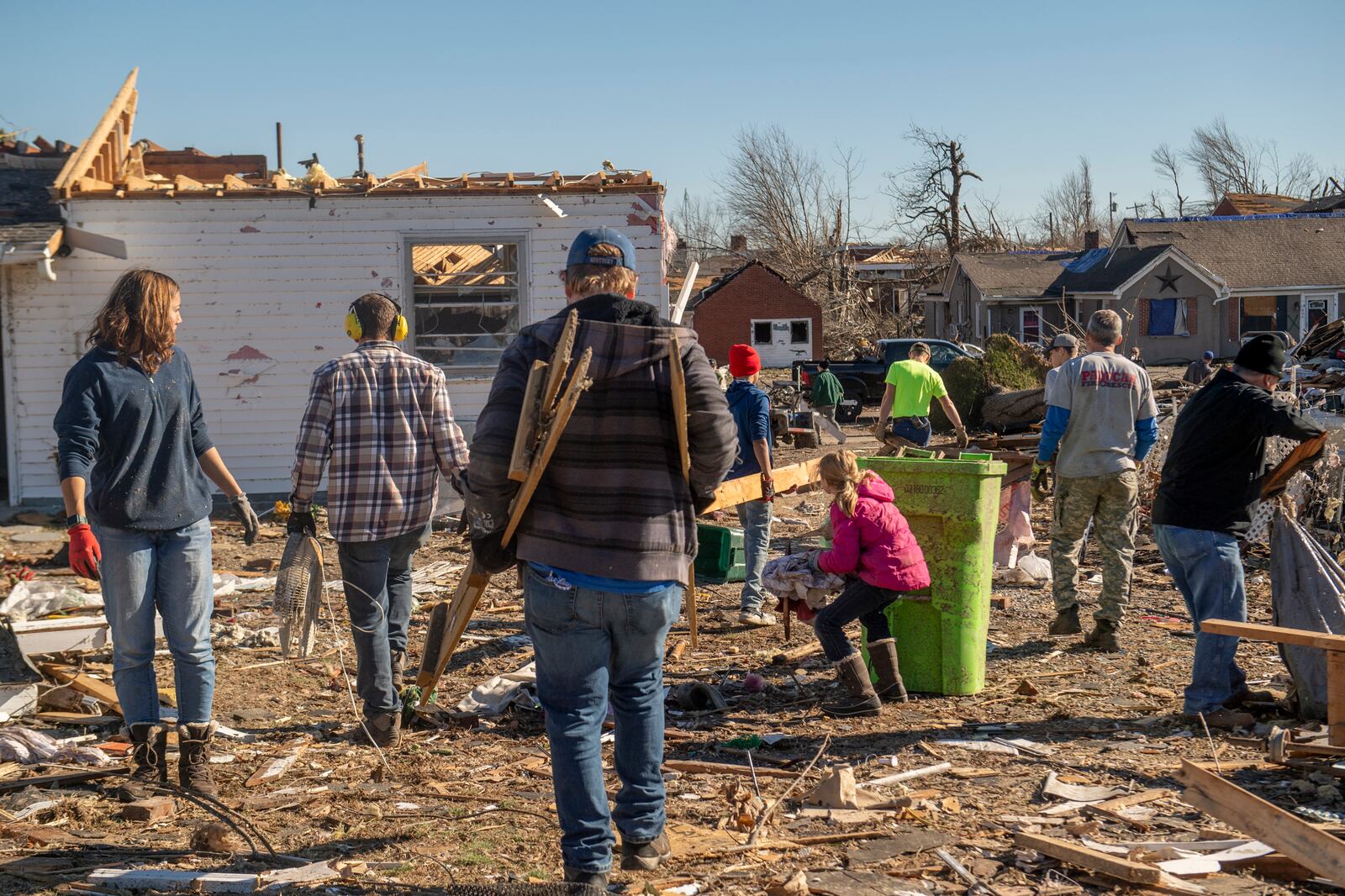 Volunteers help with the cleanup efforts in Mayfield, Ky. on Monday, Dec. 13, 2021, after a tornado swept across the region. Determining how many people died in the tornadoes that ravaged the central U.S. on Friday has been a challenging task so far, with estimates fluctuating as search teams continue to spread out amid vast fields of rubble in an effort to rescue the living and account for the dead.(Johnny Milano/The New York Times)