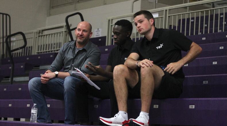 Nick Elam, left, talks to Red Scare co-founders Jeremiah Bonsu, center, and Joey Gruden during The Basketball Tournament on Friday, July 19, 2019, at Capital University in Bexley. Elam is a 2004 UD graduate who created the Elam Ending, a new way of ending basketball games that is being used by The Basketball Tournament. David Jablonski/Staff