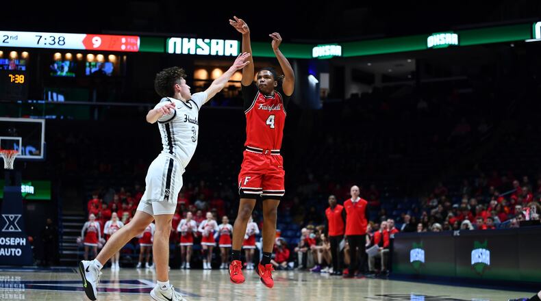 Fairfield's Michael Lewis puts up a shot over Lakota East's Ashton Washburn (3) in a Division I regional semifinal on Wednesday night at Xavier University's Cintas Center. Kyle Hendrix/CONTRIBUTED