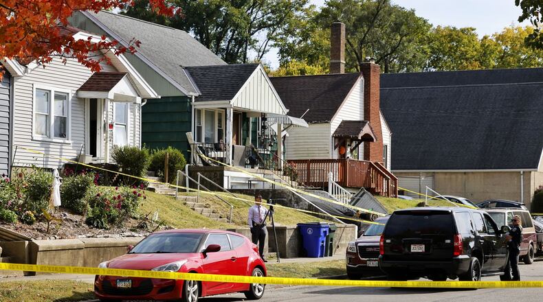Hamilton police are investigating a death at a home in the 1200 block of Parrish Avenue. Pictured are investigators at the home on Oct. 11, 2022. NICK GRAHAM/STAFF