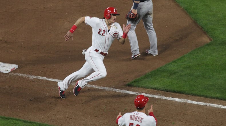 The Reds’ Derek Dietrich rounds third base and scores in the sixth inning against the Braves on Tuesday, April 23, 2019, at Great American Ball Park in Cincinnati. David Jablonski/Staff