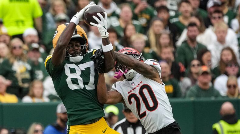 Green Bay Packers wide receiver Romeo Doubs (87) works for a catch against Cincinnati Bengals cornerback DJ Turner II (20) in the first half of an NFL football game, Sunday, Oct. 12, 2025, in Green Bay, Wis. (AP Photo/Morry Gash)