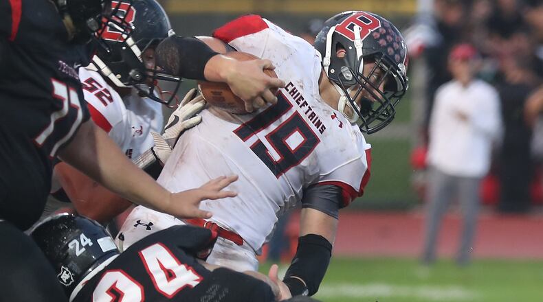 Bellefontaine’s Garrett Gross breaks a tackle. BILL LACKEY/STAFF