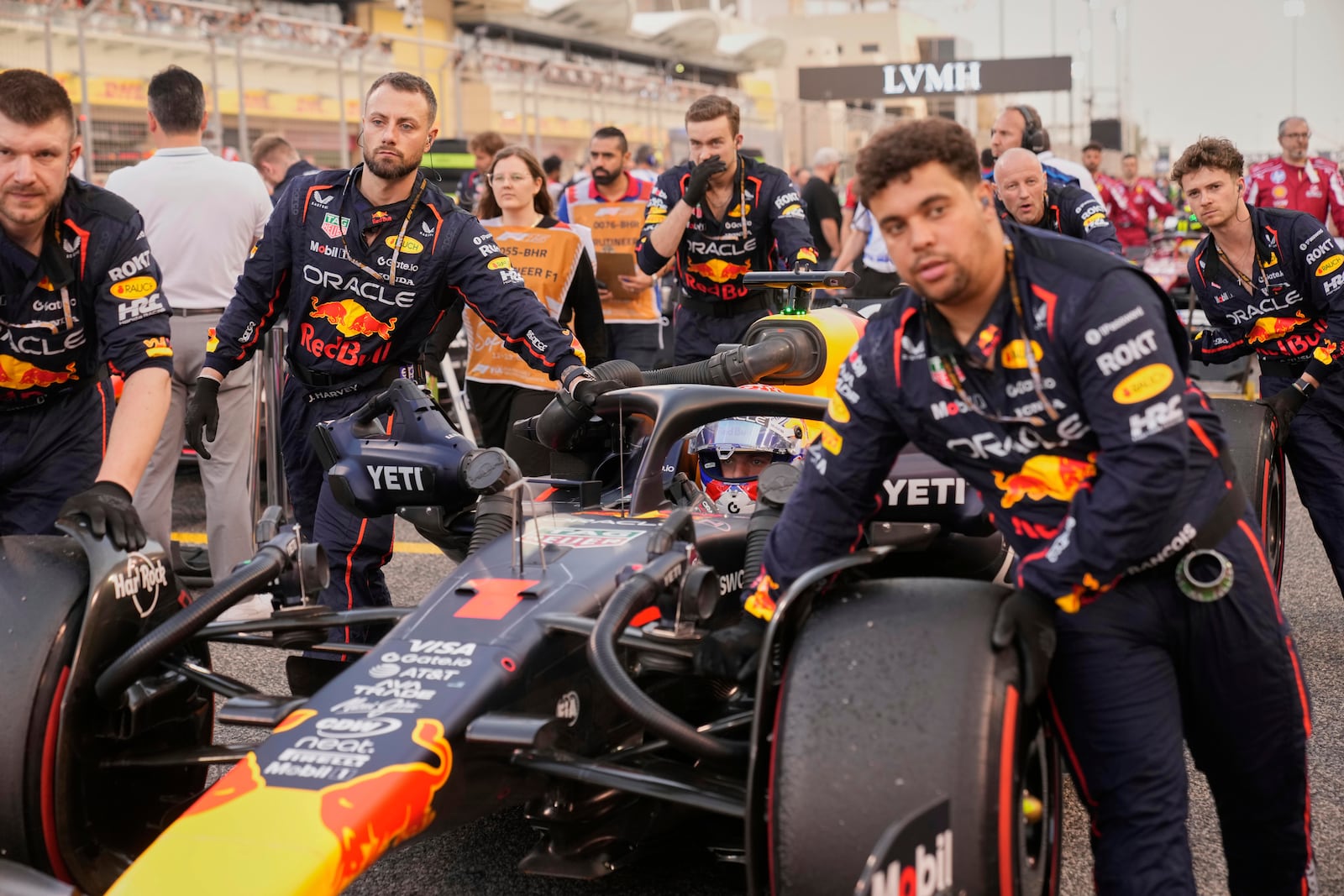Mechanics push Red Bull driver Max Verstappen of the Netherlands on the starting grid before the the Formula One Bahrain Grand Prix, in Sakhir, Sunday, April 13, 2025. (AP Photo/Darko Bandic)