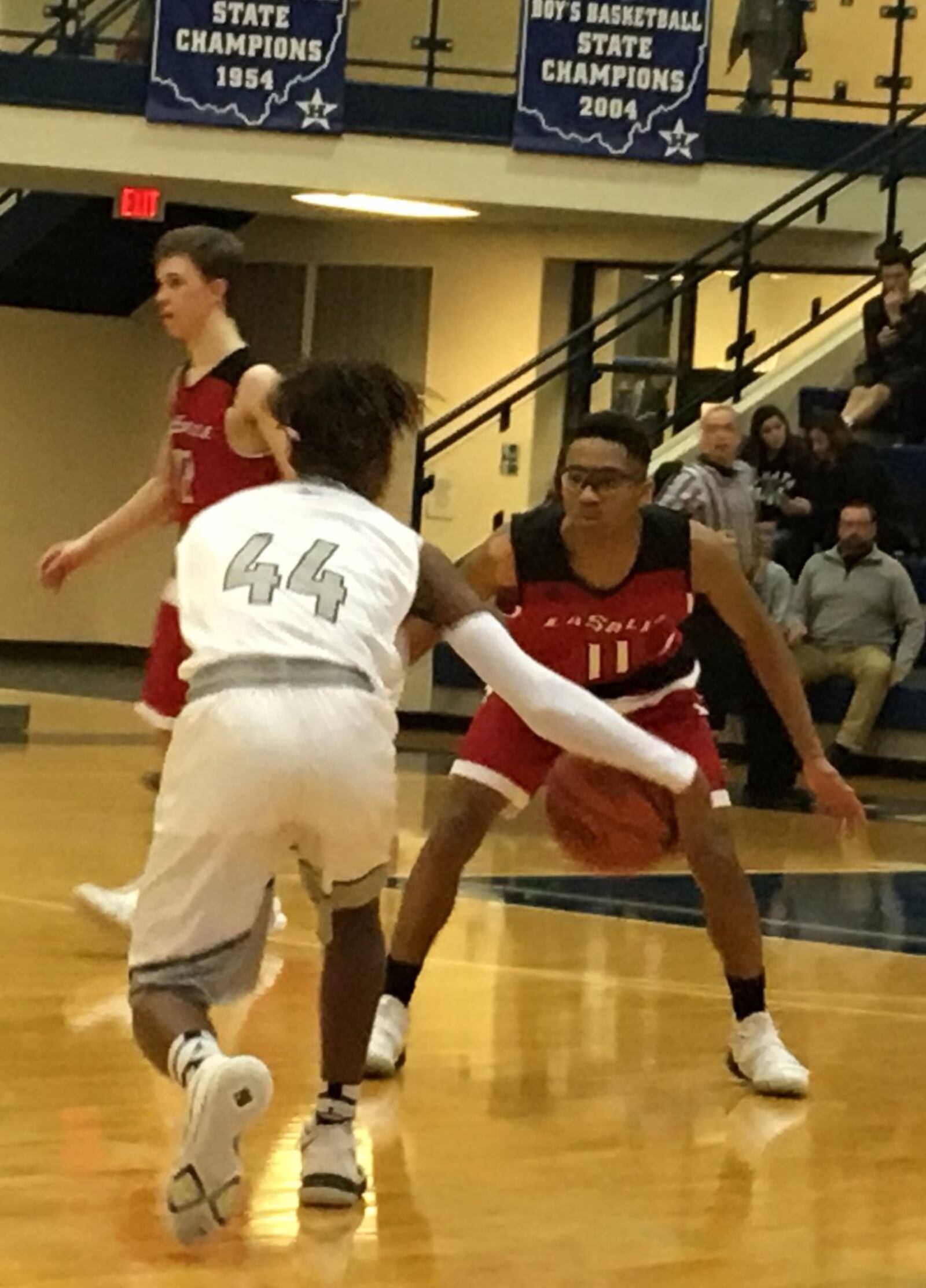 La Salle’s Quinn Ealy (11) takes defensive aim at Lakota East’s Jalen Peck (44) during Friday night’s Division I sectional final at the Hamilton Athletic Center. RICK CASSANO/STAFF