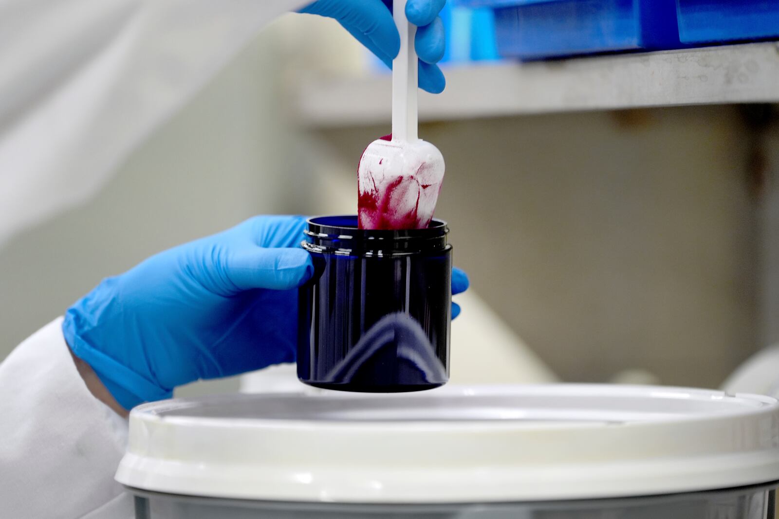 Technician Heather Browning packages a color sample made of beet powder for a customer at Sensient Technologies Corp., a color additive manufacturing company, in St. Louis., on Wednesday, April 2, 2025. (AP Photo/Jeff Roberson)