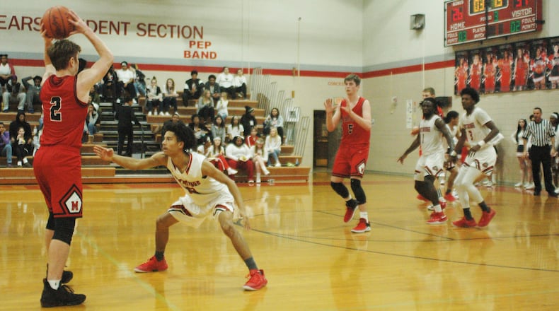 Madison’s Tristan Sipple (2) looks toward teammate Grant Whisman (5) as Northridge’s Jared Lewis (13) applies defensive pressure during Saturday night’s game in Harrison Township. Madison won 62-51. RICK CASSANO/STAFF