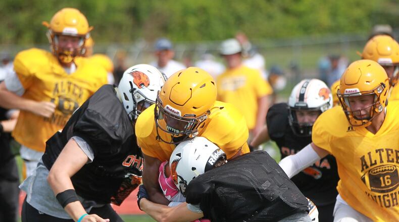 Alter High School sophomore C.J. Hicks makes a short gain during a scrimmage at Beavercreek on Saturday, Aug. 17, 2019. MARC PENDLETON / STAFF