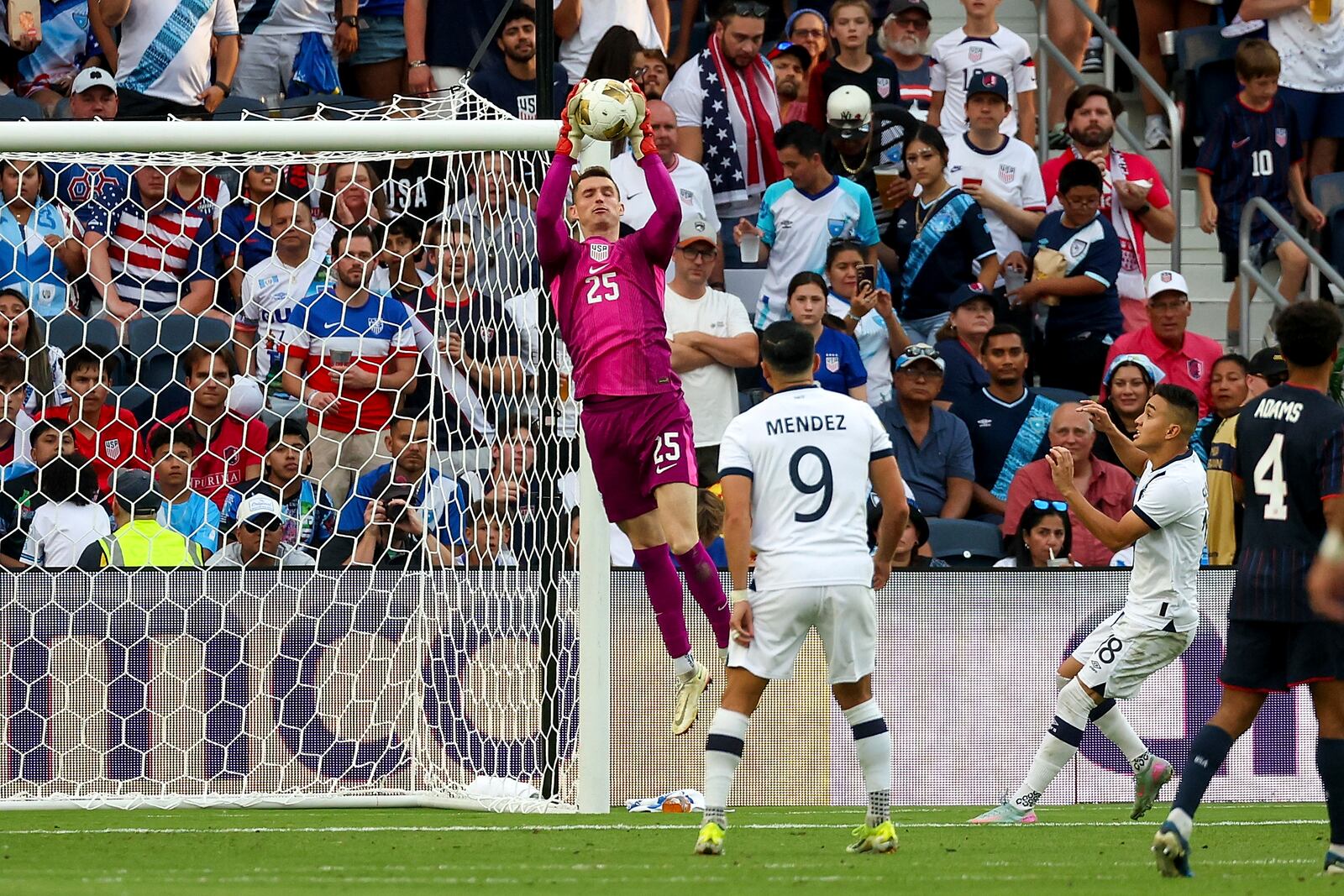 United States goalkeeper Matthew Freese (25) makes a save while Guatemala forward Rubio Mendez (9) and Oscar Santis (18) watch during the second half of a CONCACAF Gold Cup semifinal soccer match, Wednesday, July 2, 2025, in St. Louis. (AP Photo/Scott Kane)