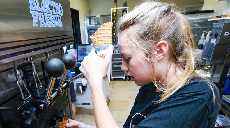 Kate Harvey, 16, makes an ice cream cone during her shift at Twist Ice Cream Company Wednesday, May 31, 2017, on Bethany Road in Liberty Twp. NICK GRAHAM/STAFF