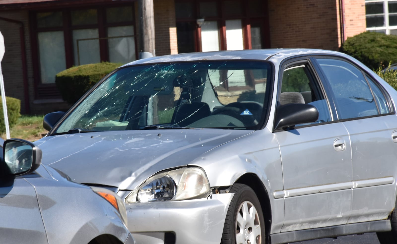 A car with front end damage and a shattered windshield parked at a fast-food business in Montgomery County. CORNELIUS FROLIK / STAFF