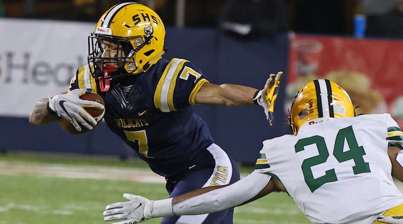 Springfield's Anthony Brown tries to avoid a tackle by St. Edward's Warren Bloodworth. BILL LACKEY/STAFF