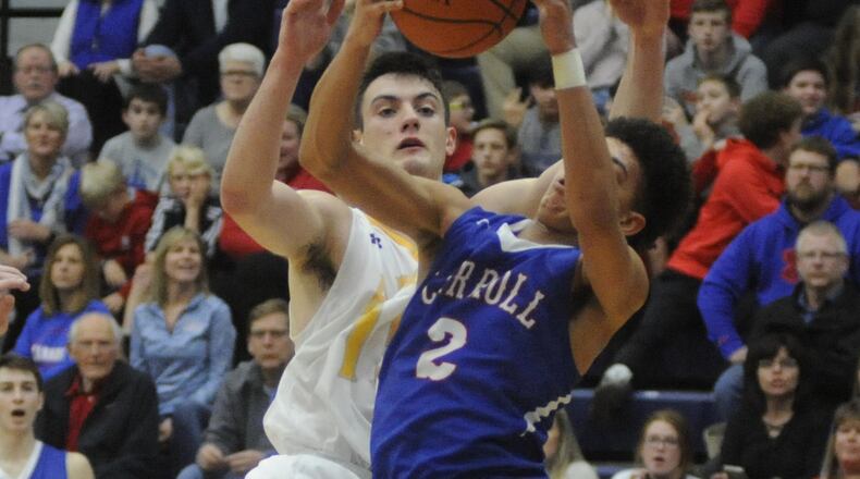 Carroll’s Eli Ramsey snaps a rebound away from Alter’s Dominic Laravie. Carroll upset Alter 53-42 in a boys high school basketball D-II sectional semifinal at Fairmont’s Trent Arena on Wednesday, March 1, 2017. MARC PENDLETON / STAFF