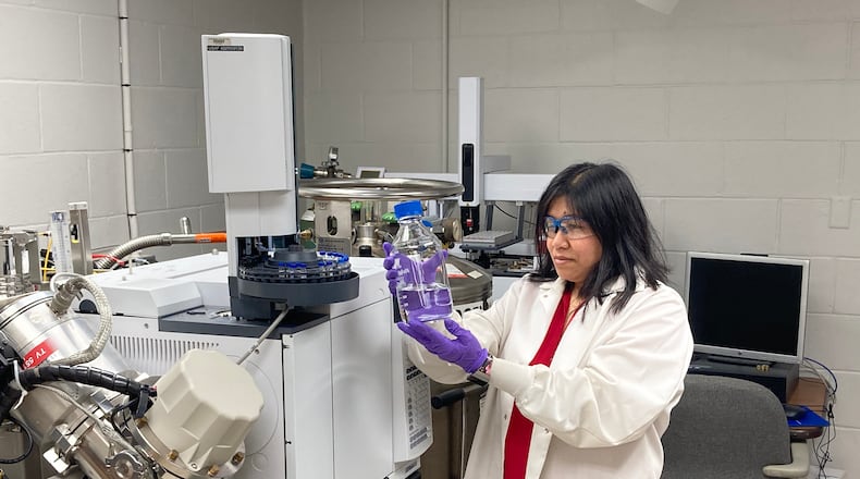 University of Dayton Research Institute fuels and combustion researcher Jhoanna Alger examines a jet fuel sample.