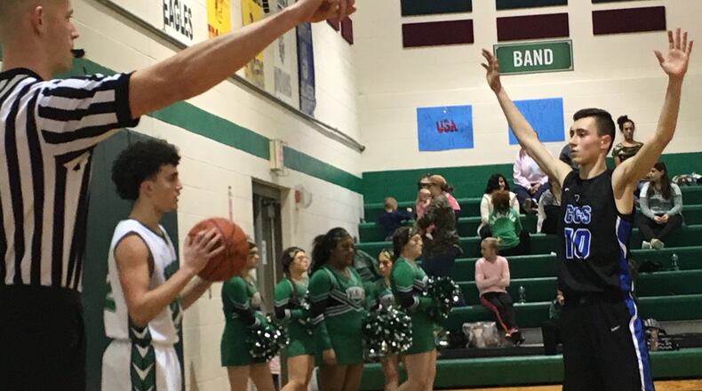 New Miami’s Jordan Robinette (22) prepares to inbound the ball as Cincinnati Christian’s Cole Martin (10) defends Tuesday night at New Miami. RICK CASSANO/STAFF