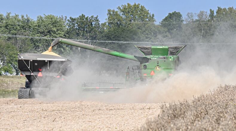 Farmers harvest soybeans in a field near Ohio 202 near Tipp City on Sept. 29, 2025. Tariffs on China and stalled trade negotiations are threatening the financial stability of soybean farmers nationwide. BRYANT BILLING / STAFF