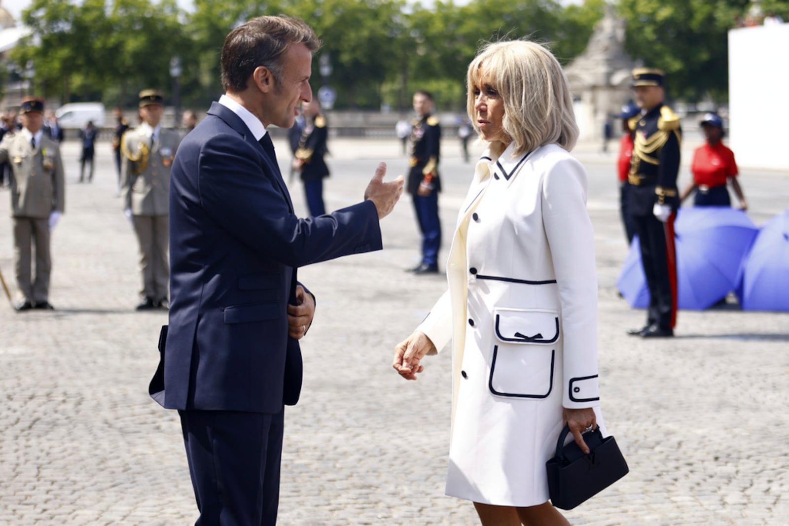 FILE - French President Emmanuel Macron and his wife Brigitte Macron as they leave the Bastille Day military parade on the Champs-Elysees avenue, Monday July 14, 2025. (Mohammed Badra, Pool via AP, File)