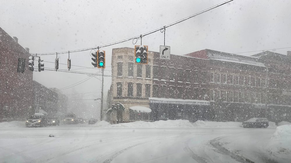 Fresh snow blows through an intersection in Lowville, N.Y., on Thursday, Jan. 22, 2026. (AP Photo/Cara Anna)