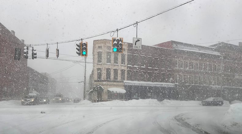 Fresh snow blows through an intersection in Lowville, N.Y., on Thursday, Jan. 22, 2026. (AP Photo/Cara Anna)