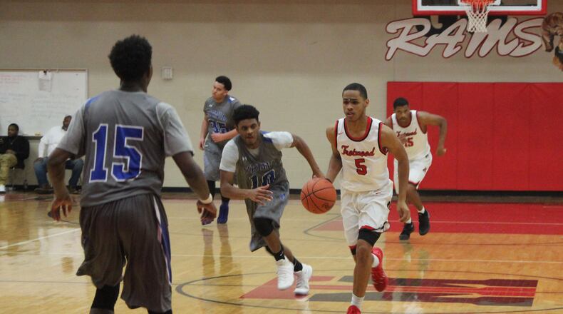 Amir Foster of Trotwood drives against the visiting Xenia defense in a boys basketball game Friday, Dec. 16, 2016. MIKE HARTSOCK / WHIO-TV