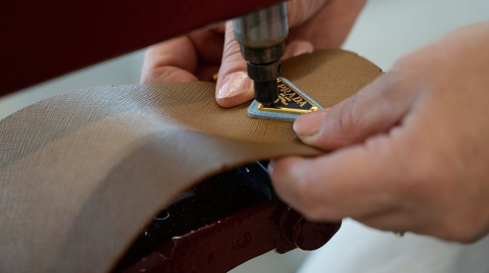 A leather good operator works at the Prada factory in Scandicci, Italy, Friday, Nov. 28, 2025. (AP Photo/Gregorio Borgia)
