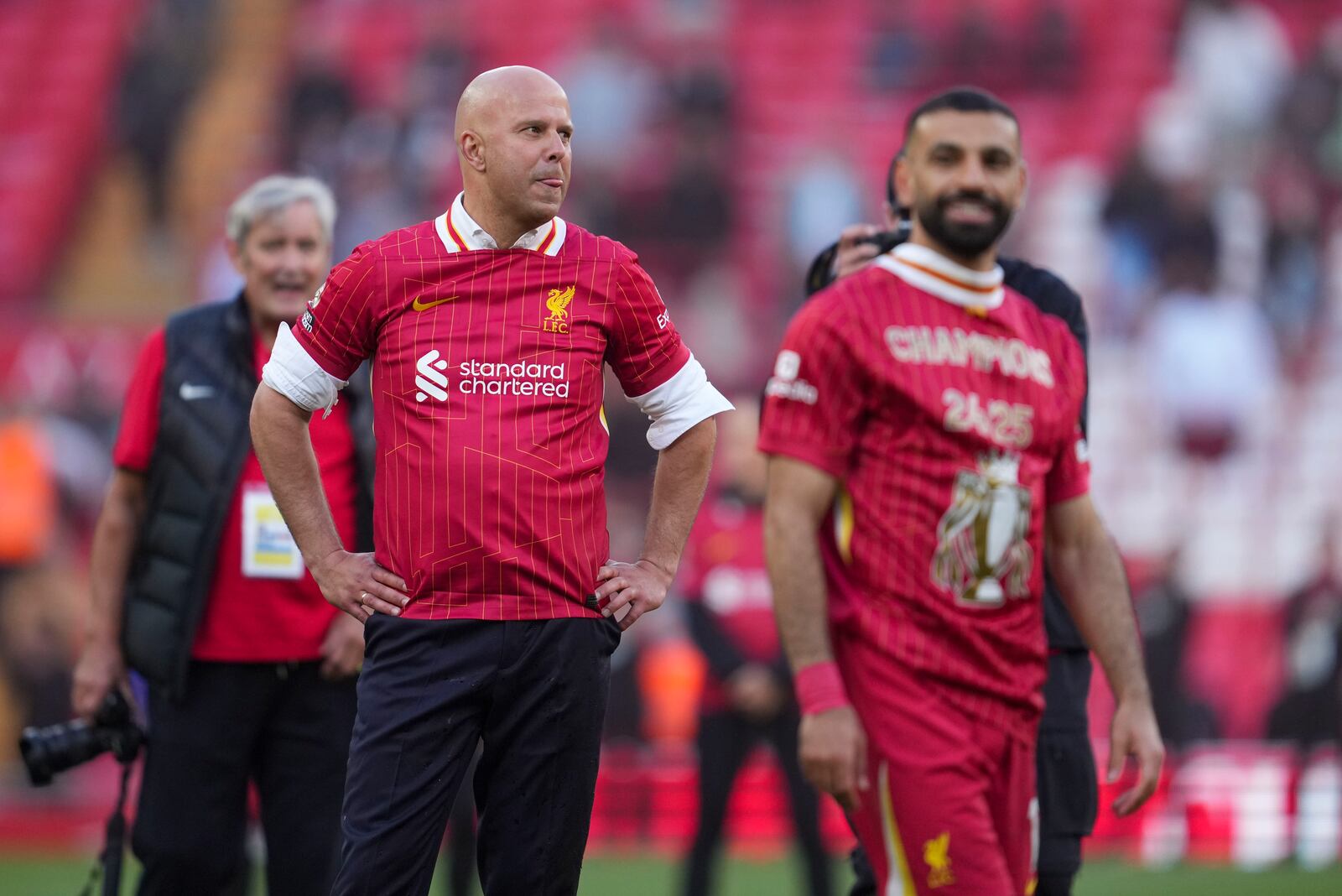 Liverpool's manager Arne Slot, left, and Liverpool's Mohamed Salah celebrate after winning the English Premier League soccer match between Liverpool and Tottenham Hotspur and clinching the Premier League title at Anfield in Liverpool, England, Sunday, April 27, 2025. (AP Photo/Jon Super)
