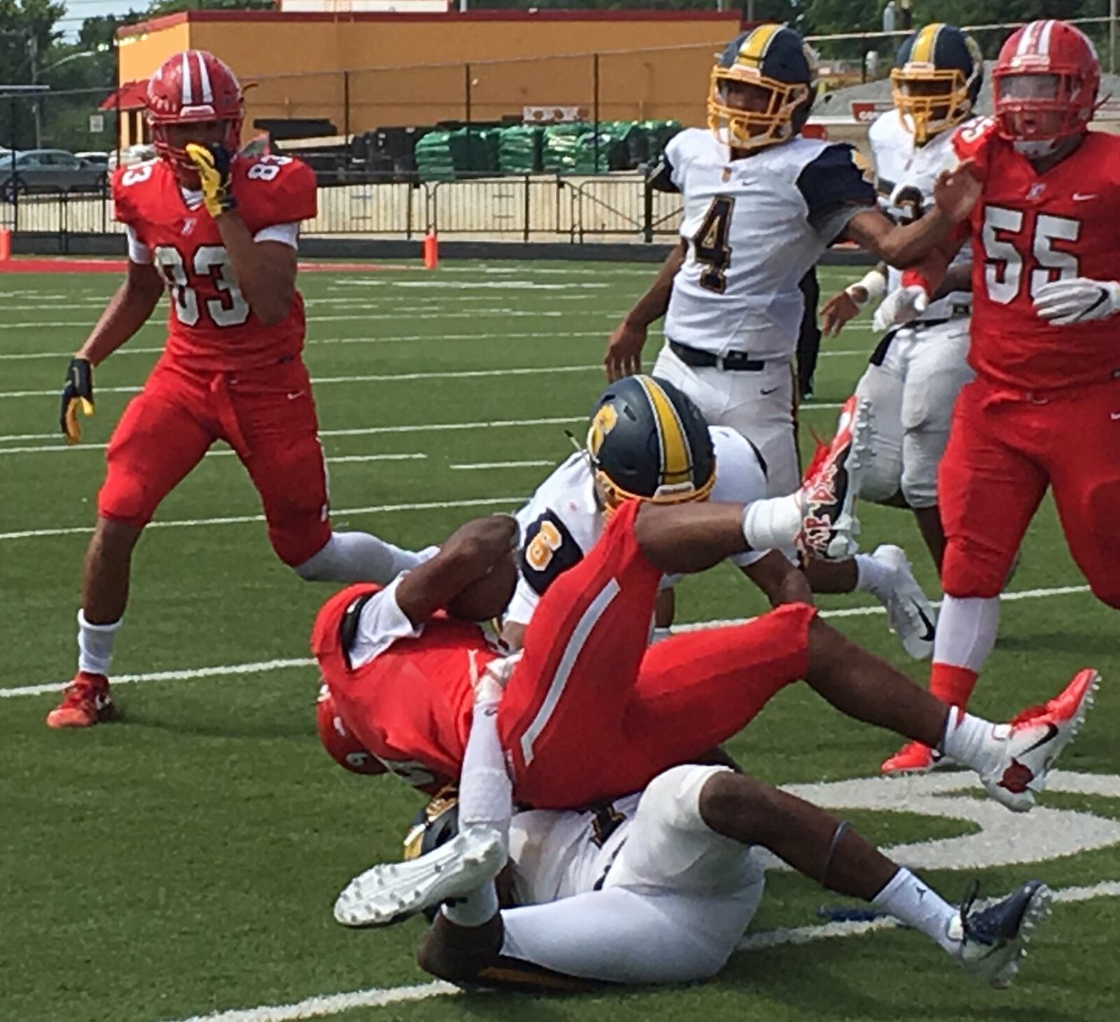 Fairfield’s JuTahn McClain (9) gets tackled by Springfield’s Jalen Minney (6) and C.J. McDavid during last Saturday’s game at Fairfield Stadium. RICK CASSANO/STAFF