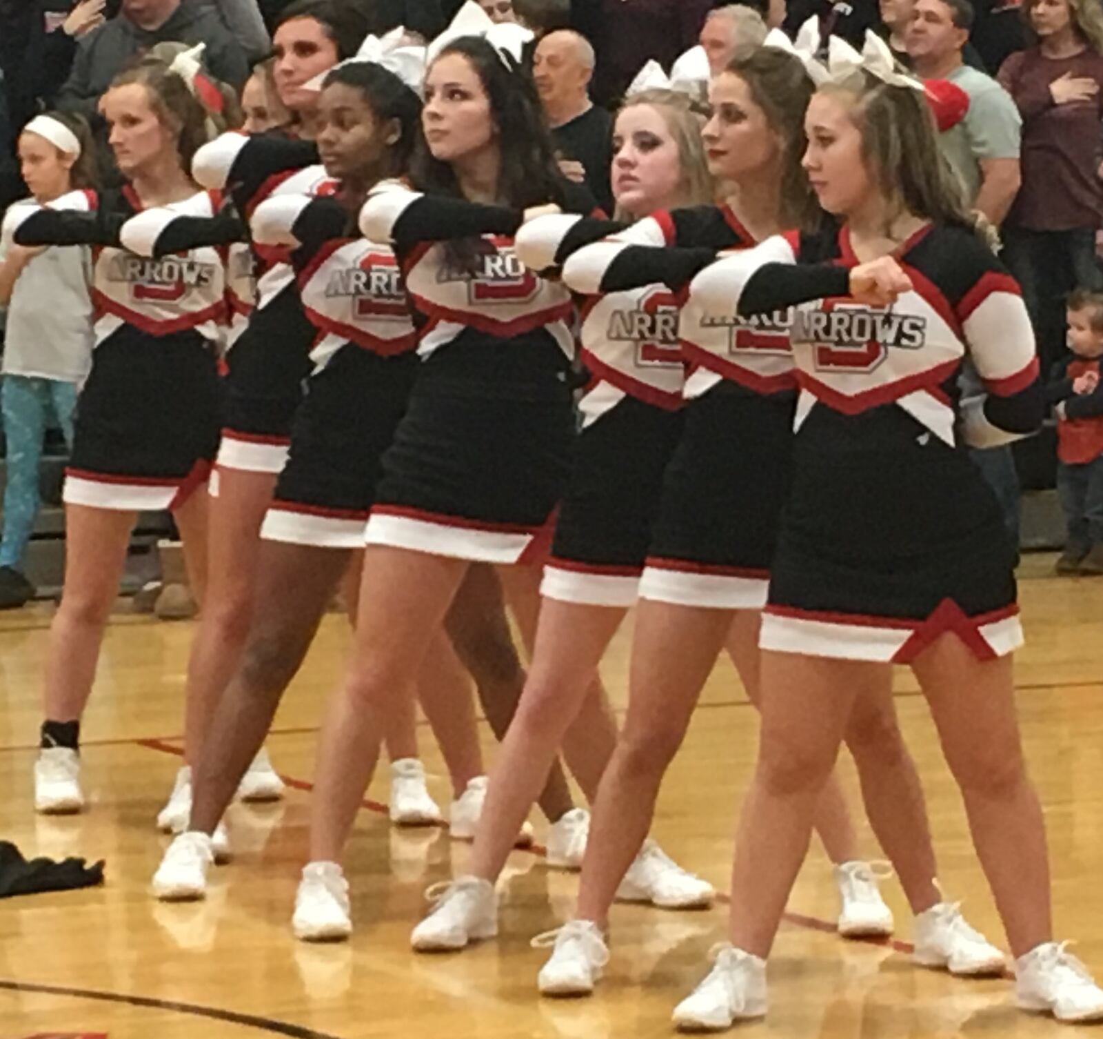 Preble Shawnee’s cheerleaders stand at attention during the National Anthem prior to Friday night’s game against visiting Madison. RICK CASSANO/STAFF