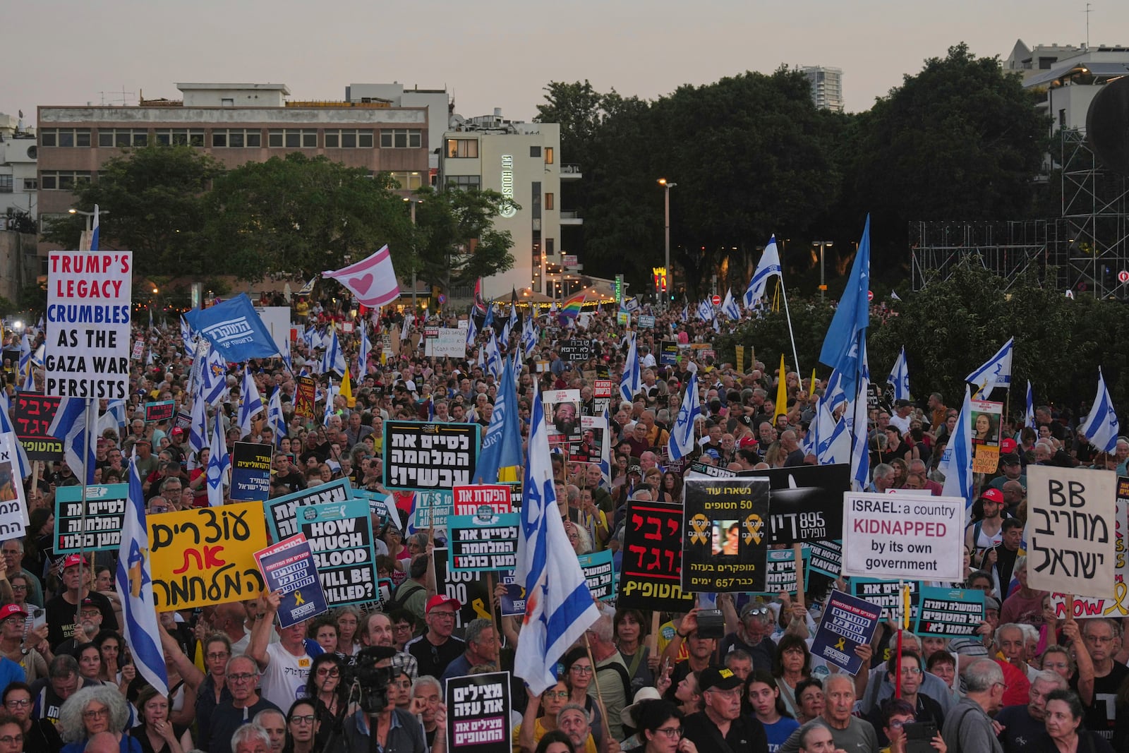 People attend a rally calling for the end of the war and the immediate release of hostages held by Hamas in the Gaza Strip, as they gather in Tel Aviv, Israel, Thursday, July 24, 2025. (AP Photo/Ariel Schalit)