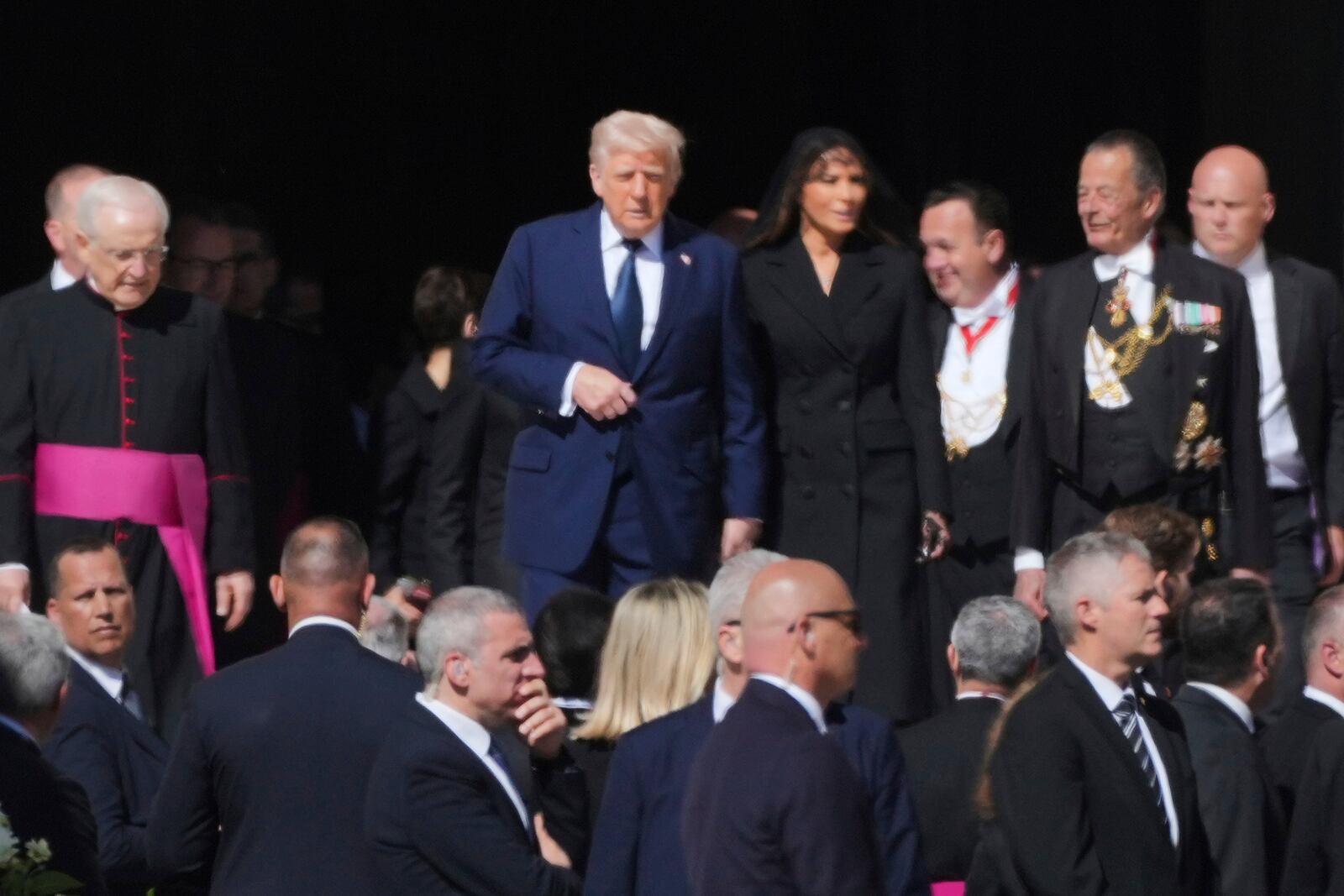 President Donald Trump and first lady Melania Trump, center, and other guests arrive, for the funeral of Pope Francis in St. Peter's Square at the Vatican, Saturday, April 26, 2025. (AP Photo/Andrew Medichini)