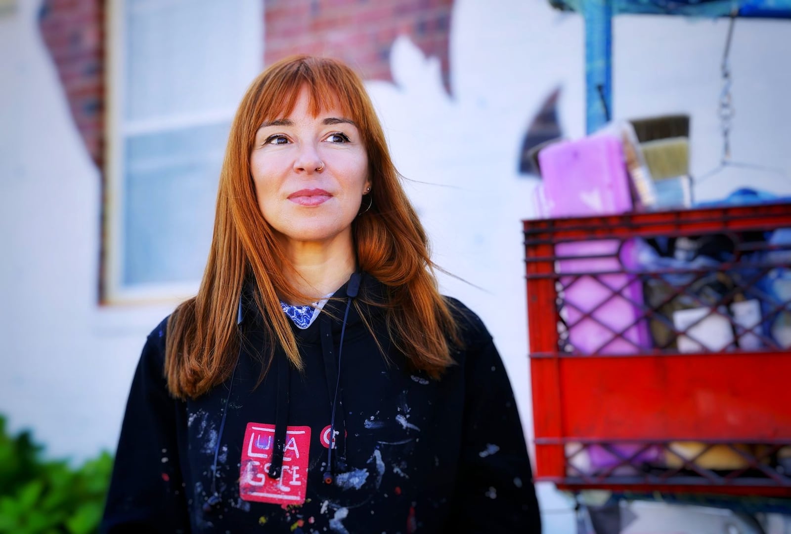 Spanish artist Lula Goce is in town painting Springboro's first public mural on the side of a building at 15 S. Main Street. Goce has traveled all over the world creating large wall murals. NICK GRAHAM/STAFF