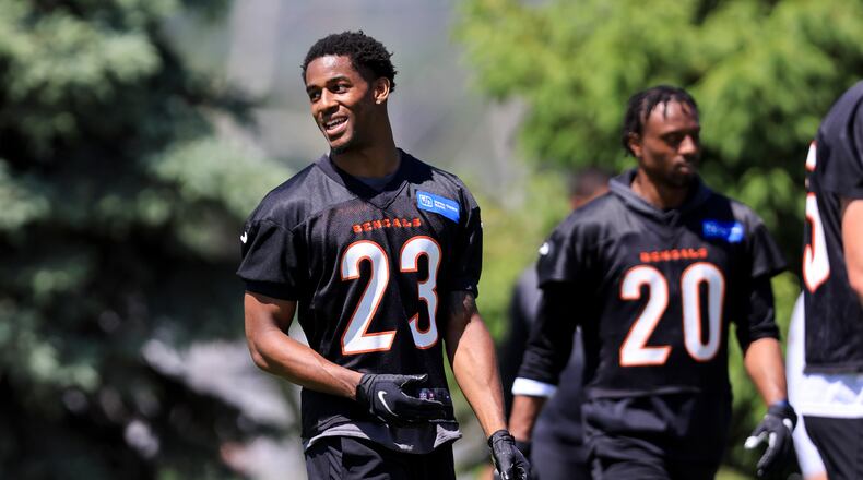 Cincinnati Bengals' Dax Hill talks with teammates during NFL football practice in Cincinnati, Tuesday, May 17, 2022. (AP Photo/Aaron Doster)